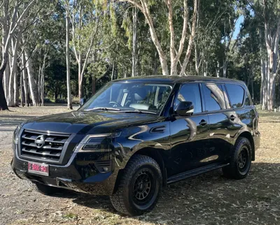Black Nissan Patrol after professional mobile car detailing in Noosa Heads, showing a glossy finish