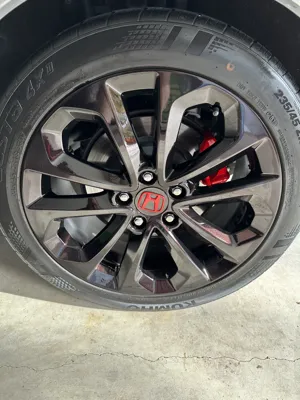 Honda wheel with red emblem polished during mobile car detailing in Maroochydore