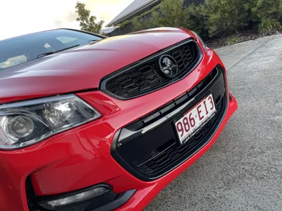 Polished red Holden front grille showing paint correction by our mobile car detailing team in Buderim