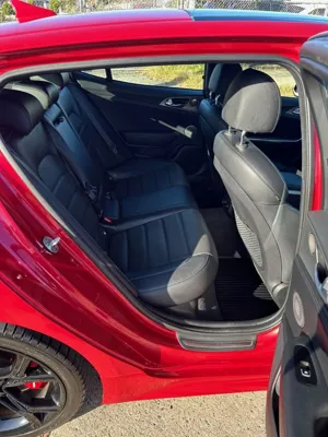 Red Kia Stinger interior detail with open door after mobile car detailing in Buderim