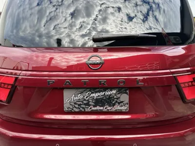 Red Nissan Patrol tailgate close-up showcasing ceramic paint protection after mobile car detailing in Noosa